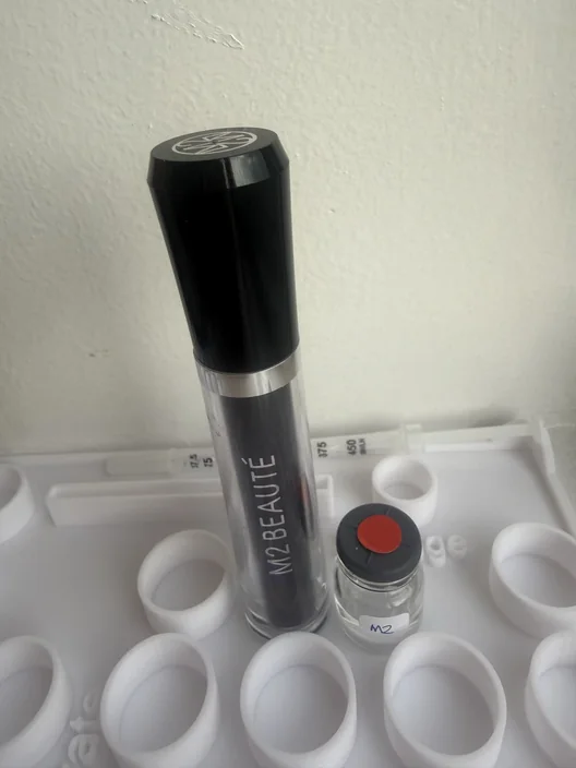 M2 Beauté tube beside its labeled test sample for The Lash List comparison