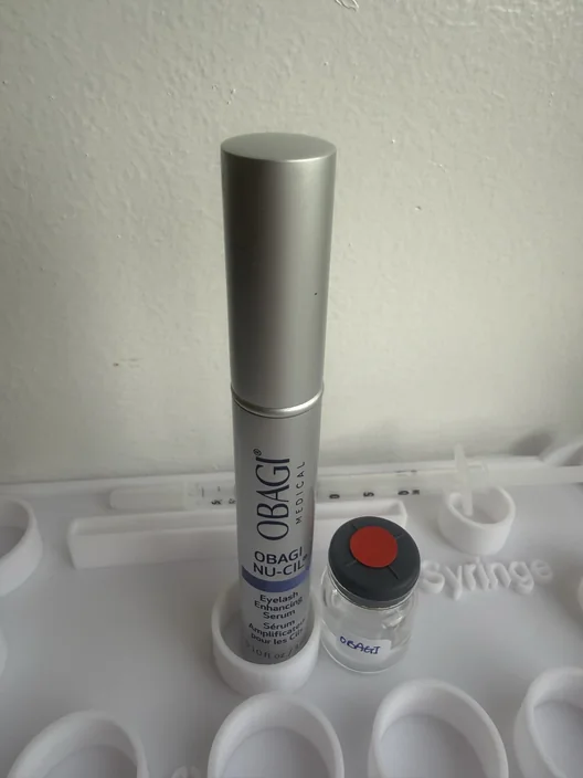 Obagi Nu-Cil tube beside its labeled test sample for The Lash List comparison