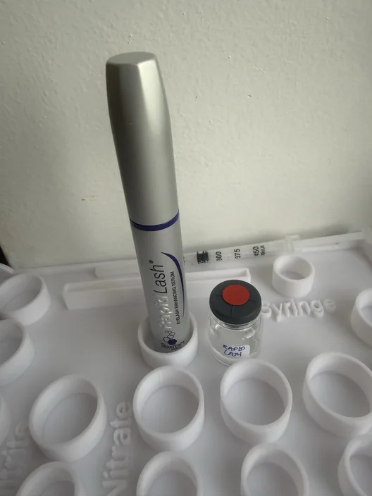 RapidLash tube beside its labeled test sample for The Lash List comparison