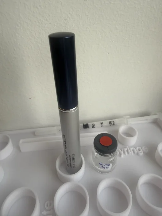 RevitaLash Advanced tube beside its labeled test sample for The Lash List comparison