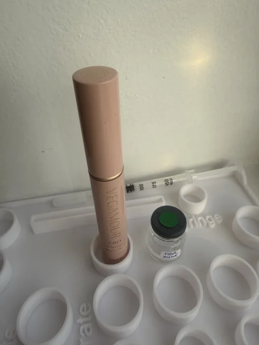 Vegamour GRO tube beside its labeled test sample for The Lash List comparison